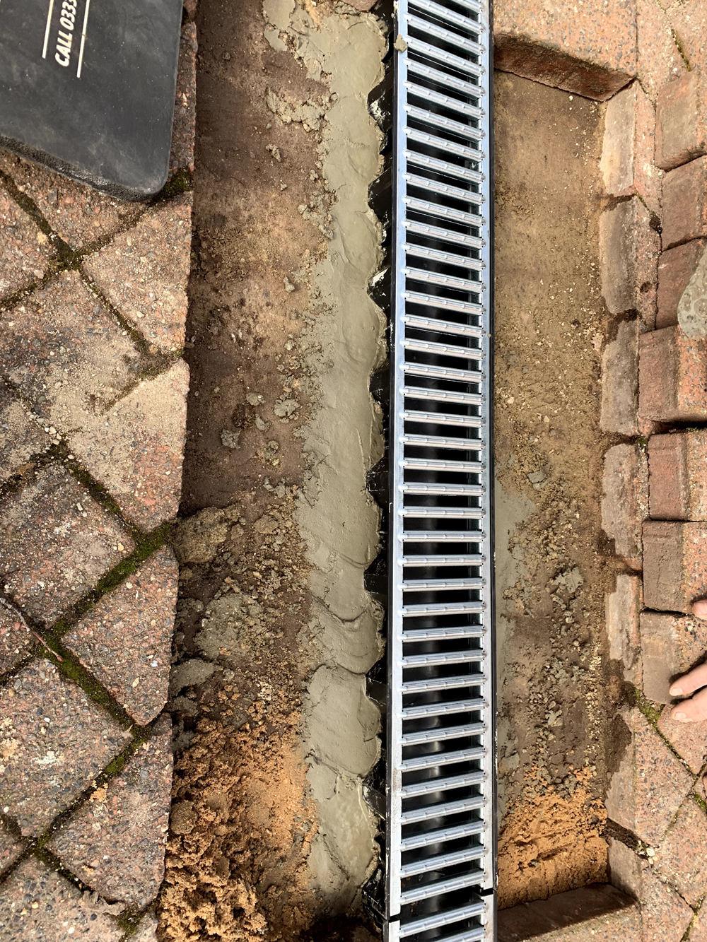 Driveway drain channel installation at an apartment block